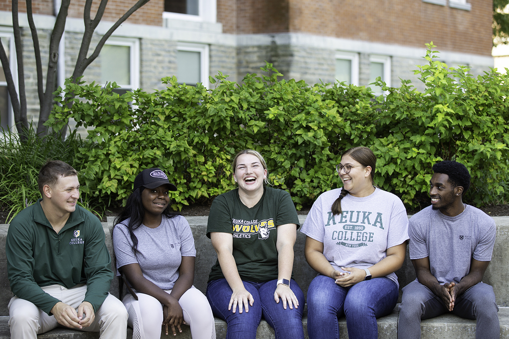 Students sitting in front of Ball Hall 