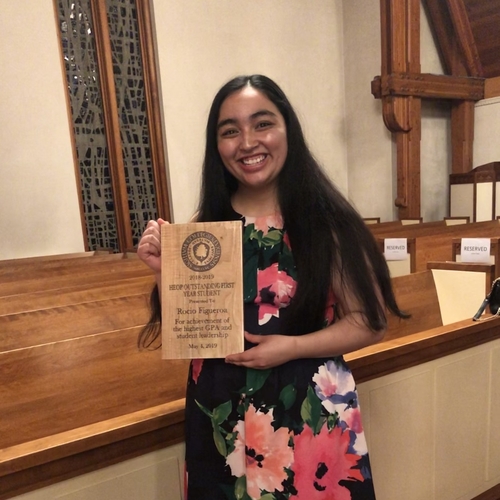 Rocio Figueroa posing with an award in the Chapel 